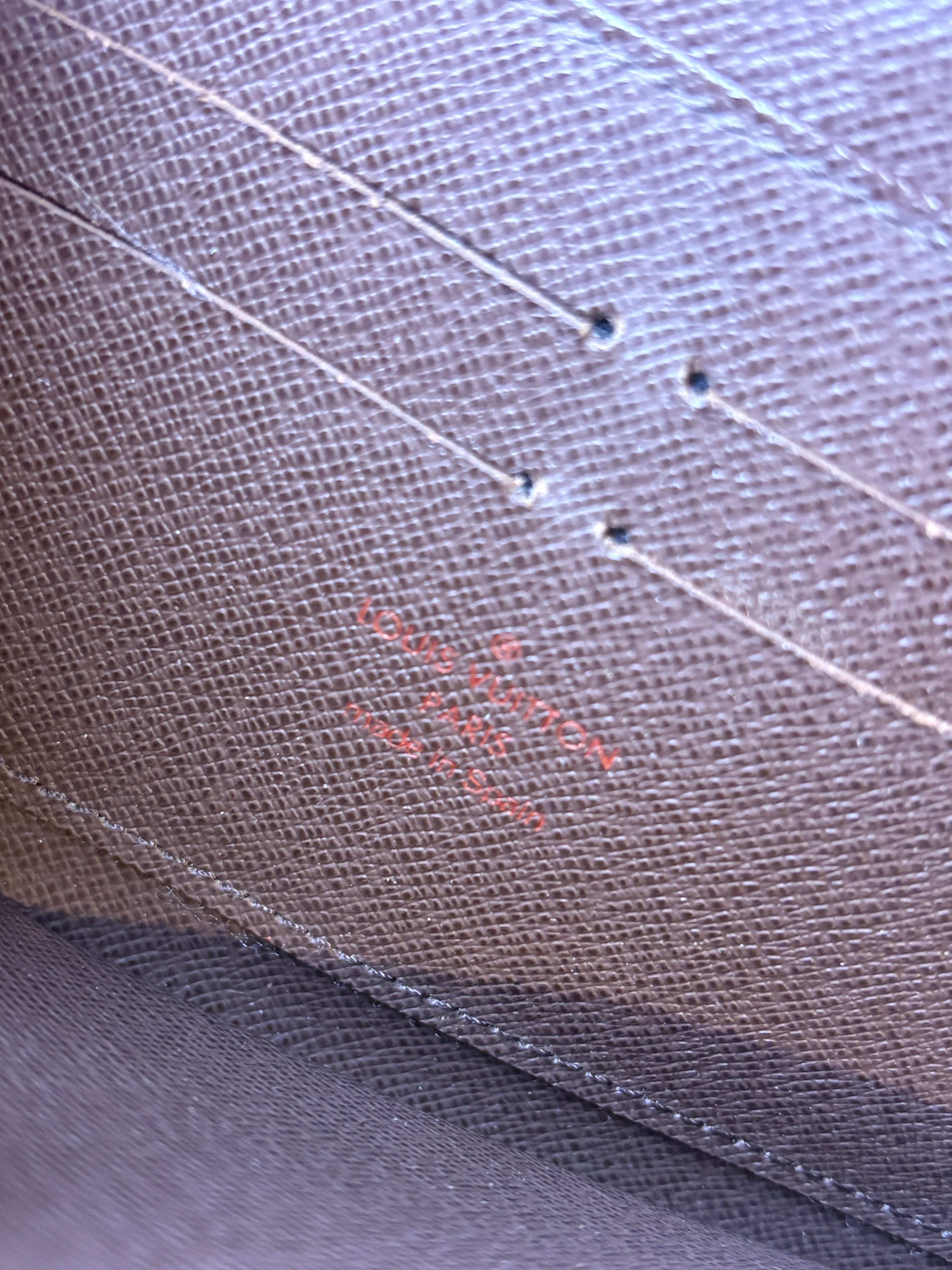 Louis Vuitton Damier Ebene Zippy Wallet logo